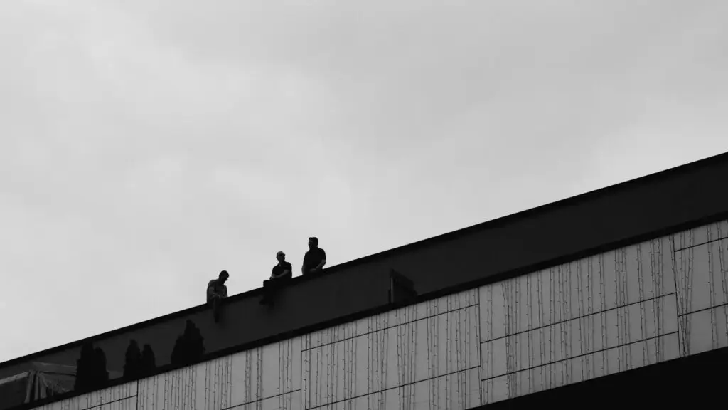 a group of people standing on top of a building